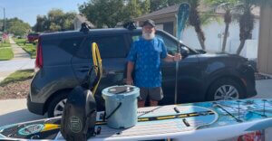 IT careers in Tampa photo of Tom Flammia with paddle boarding equipment